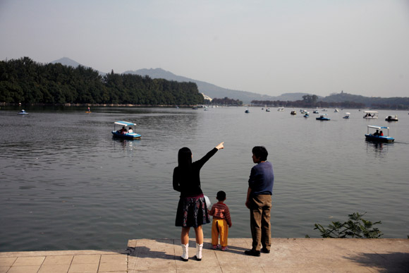 A family looks out over Xuanwu Lake in Nanjing, Jiangsu Province, China. A family looks out over Xuanwu Lake in Nanjing, Jiangsu Province, China.