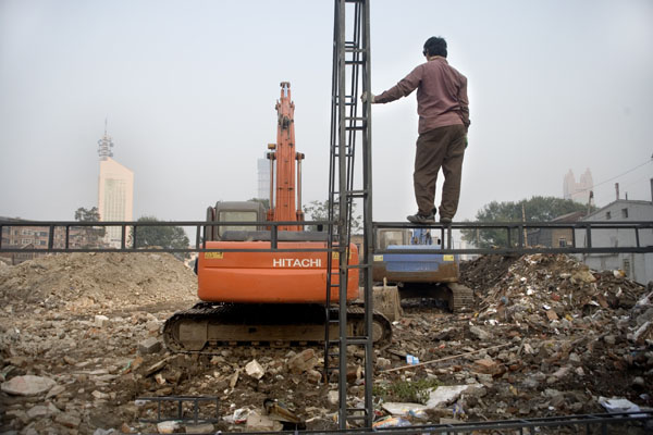 msb-116692mod Welders look over a demolition site where hutongs, small residential alleys, once stood in the center of Tianjin, China. A local resident said that the relocated residents were compensated for their houses but it was not enough. Tianjin has demolished almost all of the hutongs in the city to make way for modern construction projects.