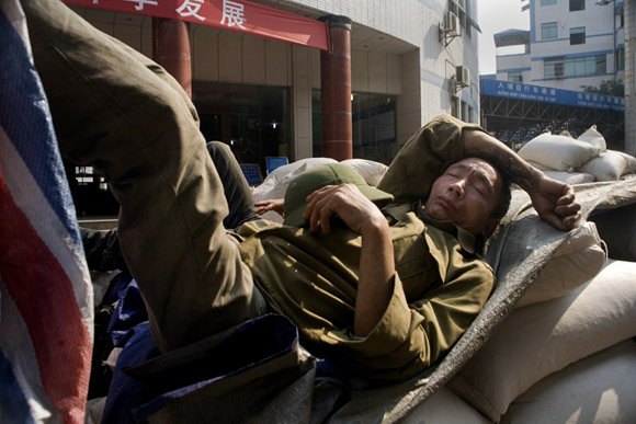 Workers wait in line at the border to take goods into Vietnam from Hekou, Yunnan Province, China.