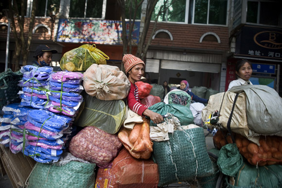 Workers wait in line at the border to take goods into Vietnam from Hekou, Yunnan Province, China.