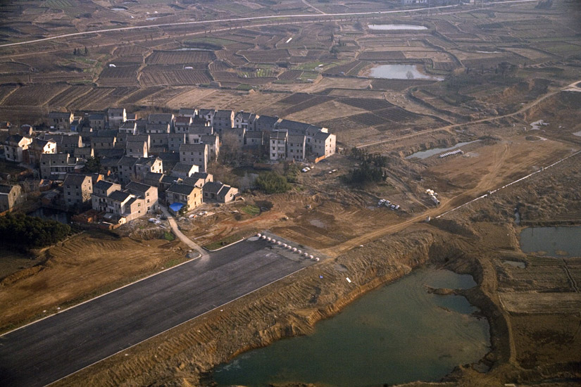 Houses and farm plots and fields divide the landscape outside of Nanjing, Jiangsu Province, China.