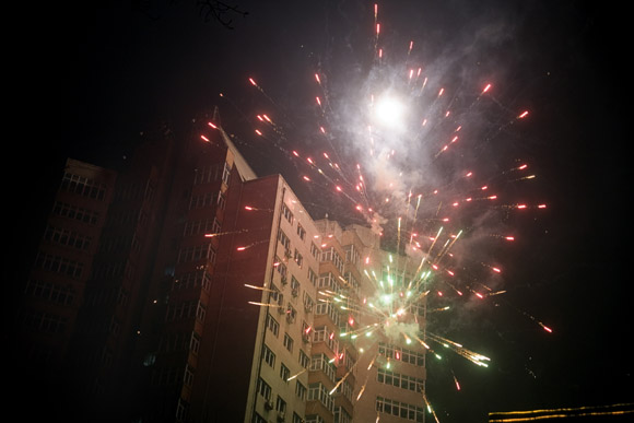 Fireworks bounce off highrise apartment buidings during Lantern Festival celebrations in central Haerbin, Heilongjiang Province, China.