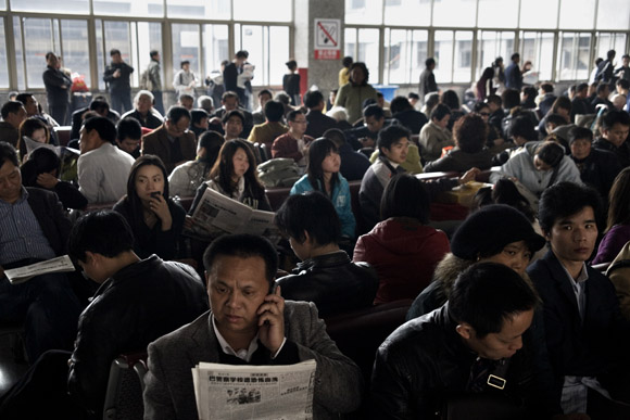 Crowds wait for their trains at the Shanghai Railway Station in Shanghai, China.