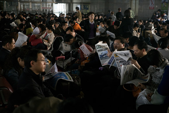 Crowds wait for their trains at the Shanghai Railway Station in Shanghai, China.