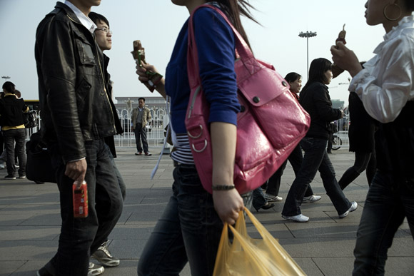Tourists walk around the north end of Tiananmen Square near the Forbidden City in Beijing, China.