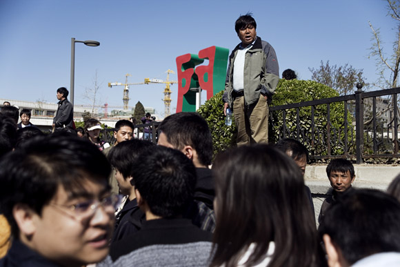 Tourists line up at the Deshengmen Gate in Beijing, China, for public buses to the Badaling entrance of the Great Wall.