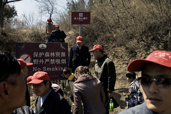 Tourists and tour groups gather outside the Badaling tourist area of the Great Wall outside Beijing, China.