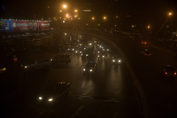Cars travel along a roadway in Beijing, China.