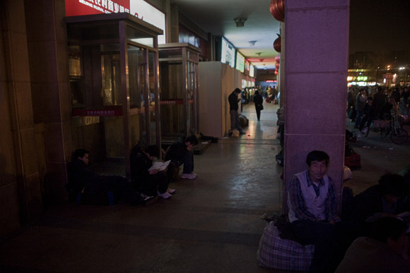 People wait for trains outside the Beijing West Railway Station in Beijing, China.