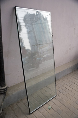 A small pane of glass reflects new development in the Bund area of central Shanghai, China.