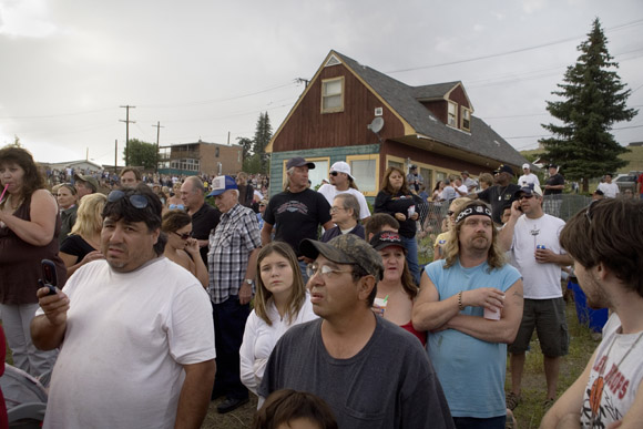 Crowds gather to watch Spanky Spangler's daredevil car jump stunt at the end of Evel Knievel Days in Butte, Montana, USA.