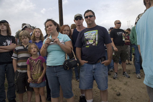 Crowds gather to watch Spanky Spangler's daredevil car jump stunt at the end of Evel Knievel Days in Butte, Montana, USA.