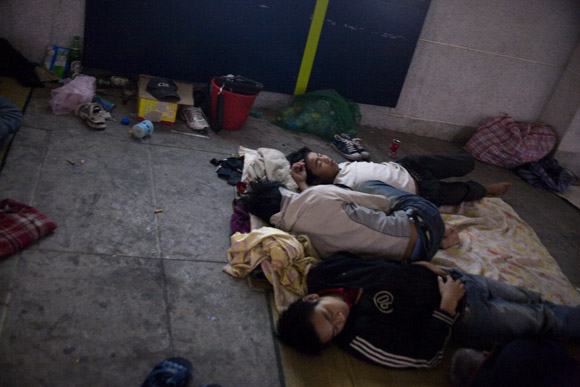 Travelers wait for trains at the Chongqing Railway Station in Chongqing, China.