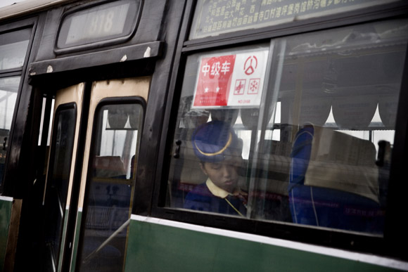 A railway worker sleeps on a bus in Chongqing, China.