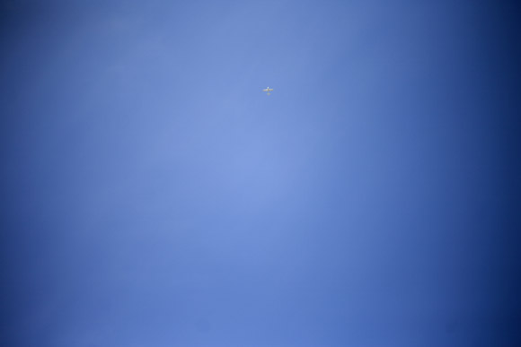 A small plane flies in the sky above Provincetown, Massachusetts, USA.