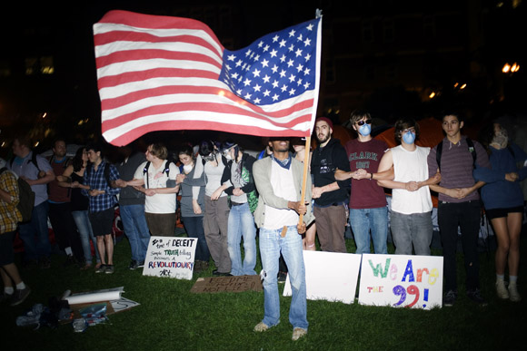 OccupyBoston protesters link arms around the tents in preparation for a planned police action at their second encampment at Rose F. Kennedy Greenway a block from Dewey Square, in downtown Boston, Massachusetts, USA.  The police and city officials warned protesters that they would be forceably removed from the site by midnight.  At about 1:30am police moved into the park, arrested approximately 100 protesters, and cleared the park of all tents and other protest materials.  The protesters are part of OccupyBoston, which is part of the OccupyWallStreet movement, expressing discontent with the socioeconomic situation of the 99% of the US population who are not wealthy.  Protestors have been camping in Dewey Square since Sept. 30, 2011. Gradually, larger organizations, including major labor unions, have expressed their support for the OccupyBoston effort.
